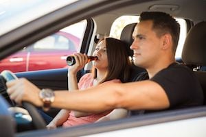 Couple drinking in a car